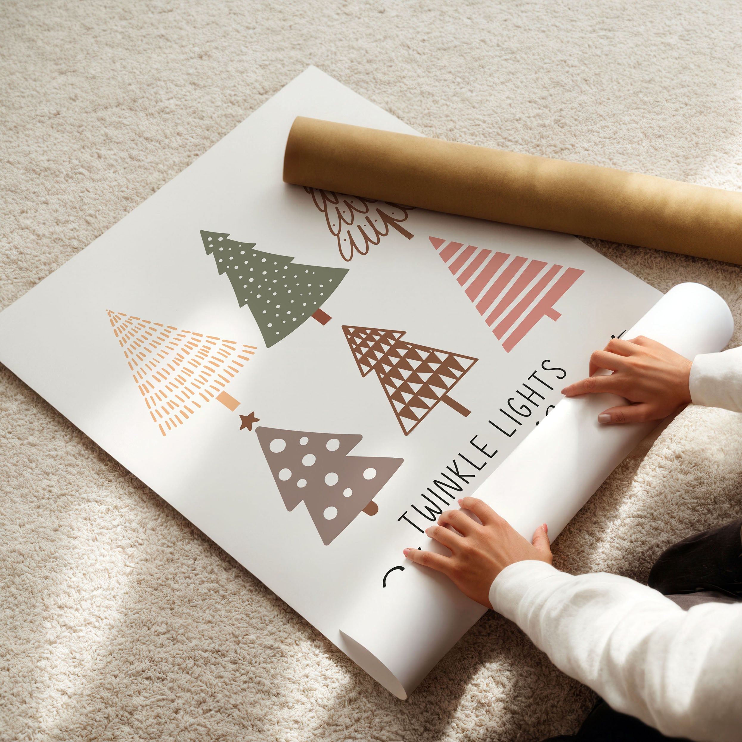 Person unrolling a roll of paper with Christmas tree designs on a carpeted floor.