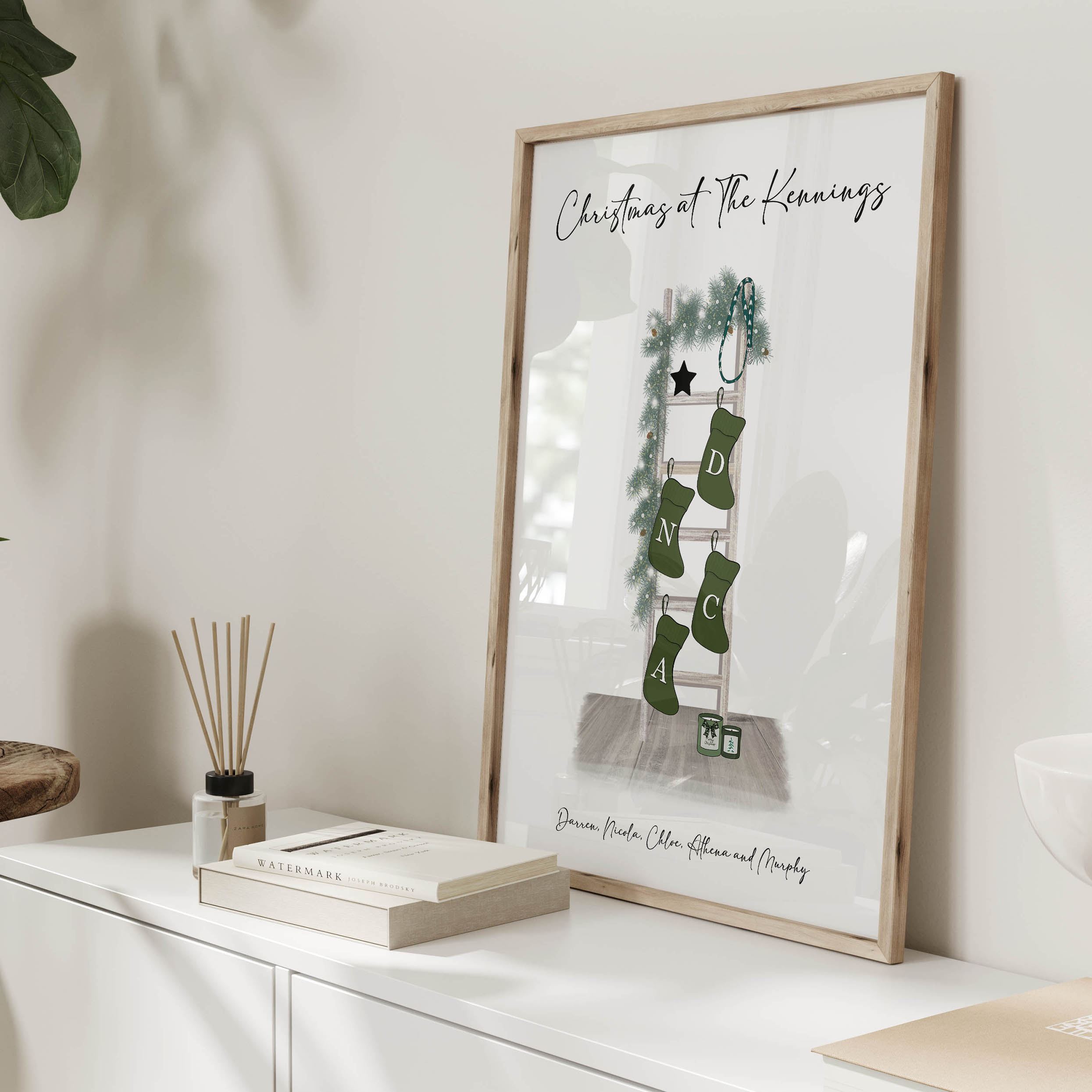 Framed personalised family Christmas stocking print displayed in cosy home