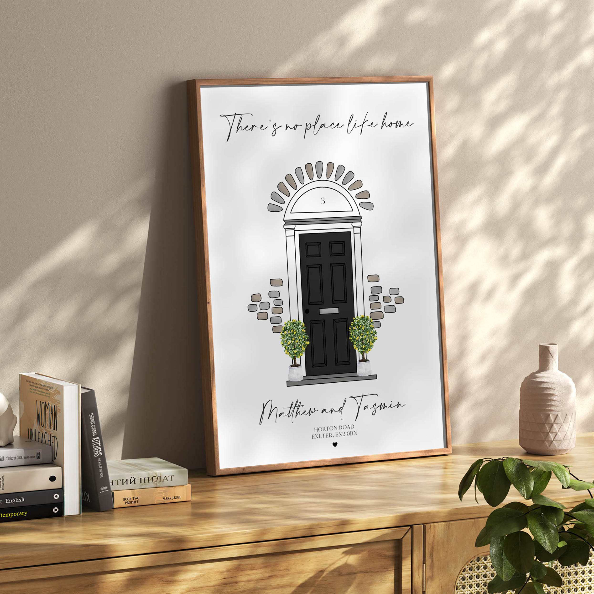 Framed personalised front door wall art displayed in modern hallway